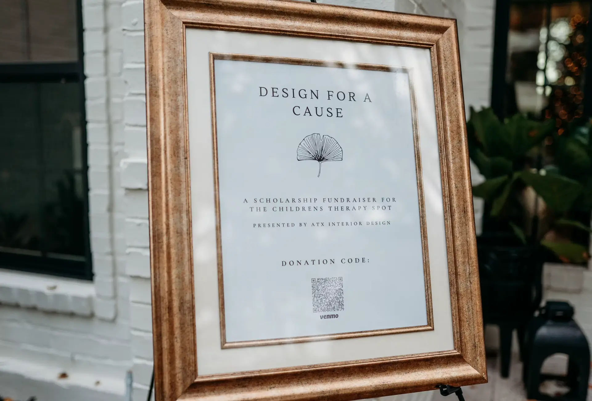 Design for a Cause welcome sign in a gilded frame