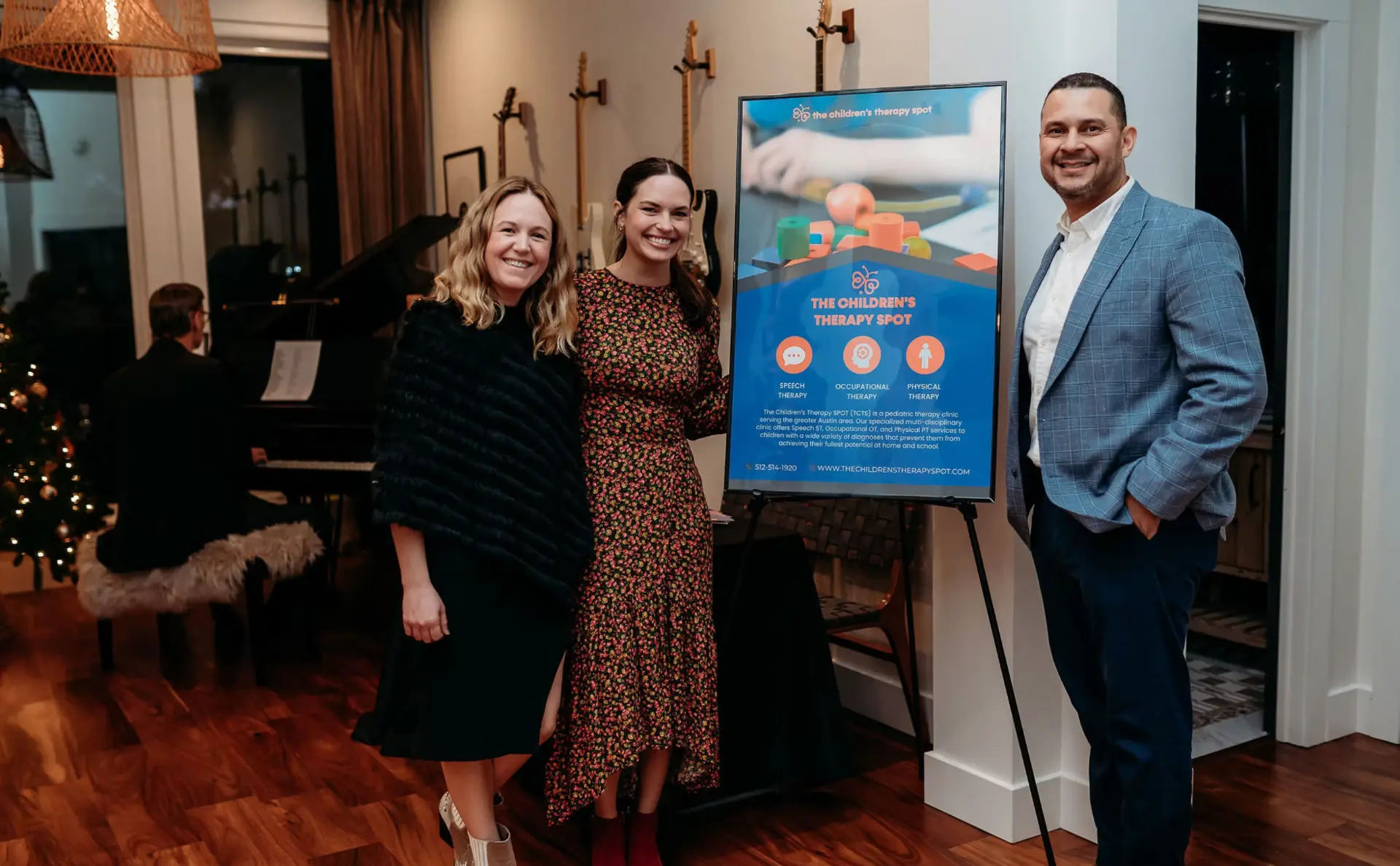 Guests beside The Children's Therapy Spot sign
